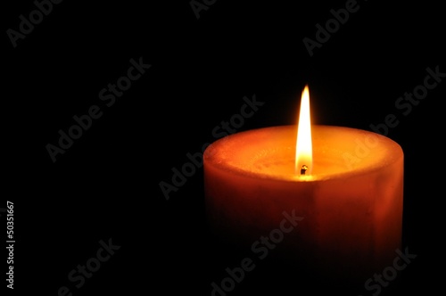 Candle on right of the frame with black background