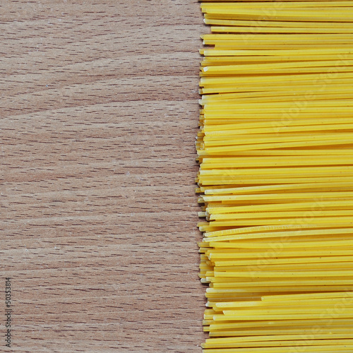Spaghetti on the wooden background