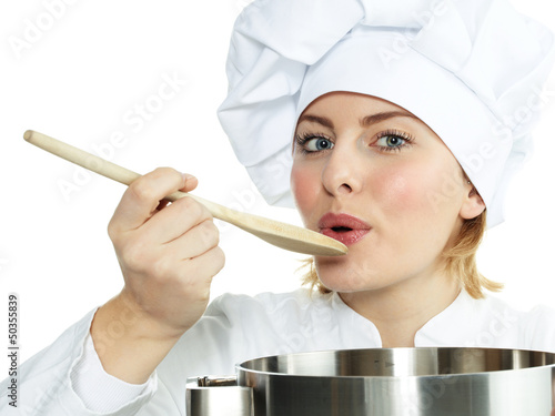 Female chef cook tasting delicious soup photo