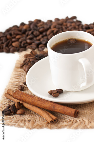closeup view of a cup of coffee and coffee beans