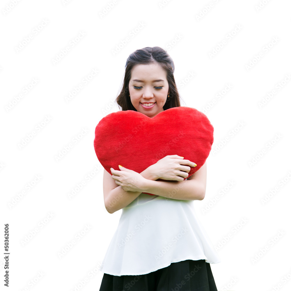 Women holding big love heart shape pillow isolated on white back Women holding big love heart shape pillow isolated on white back