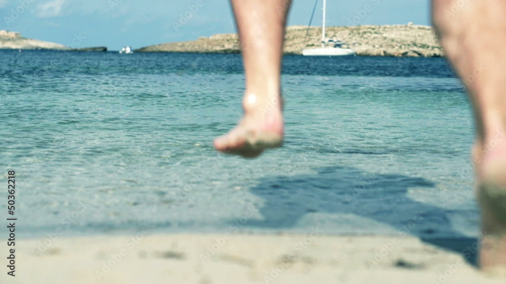 Man jumping into the sea, slow motion shot at 120fps Man jumping into the sea, slow motion shot at 120fps
