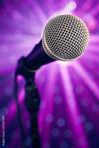 microphone against purple rays background