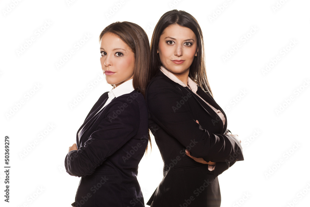 Two business women posing on white background