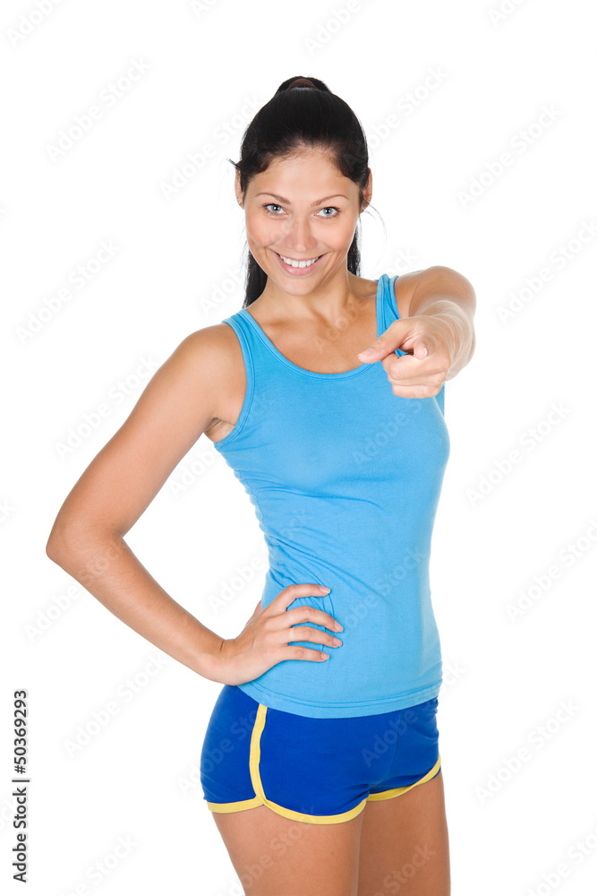 smiling athletic woman pointing his finger at you. isolated smiling athletic woman pointing his finger at you. isolated