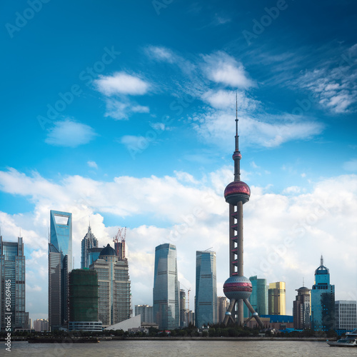 shanghai skyline against a blue sky