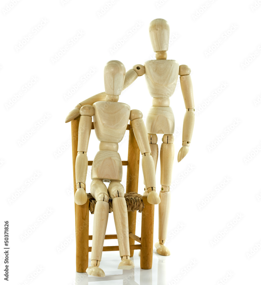 giving healthcare to wooden puppet sitting on chair giving healthcare to wooden puppet sitting on chair
