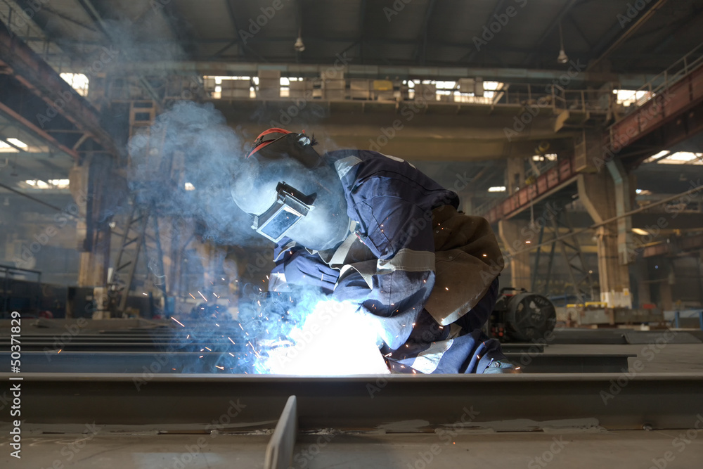 welder in factory and smoke rising welder in factory and smoke rising