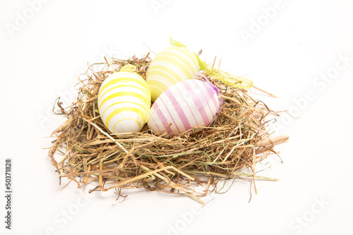 Three easter eggs in straw