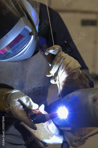 welder in factory welding inox