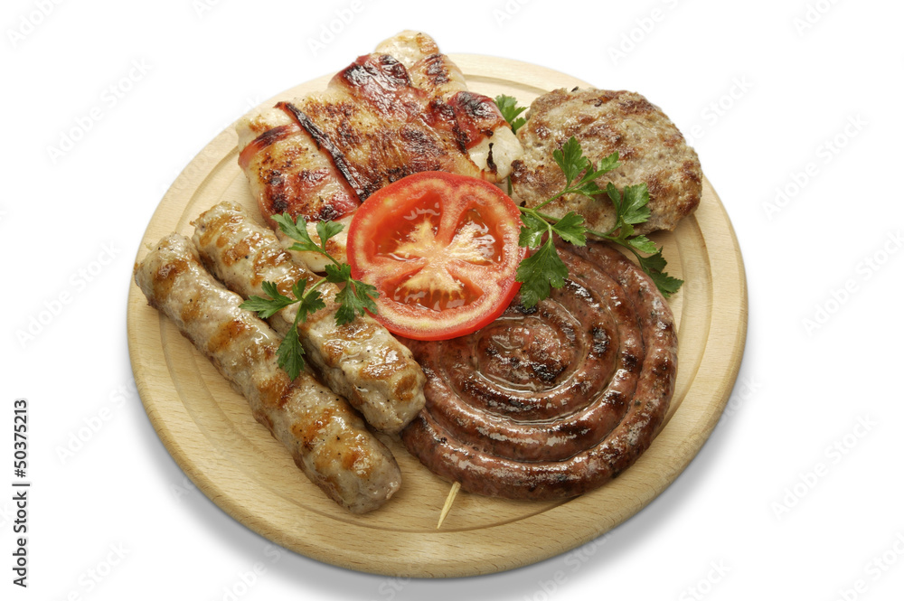 mixed grill of pork on a wooden mat mixed grill of pork on a wooden mat