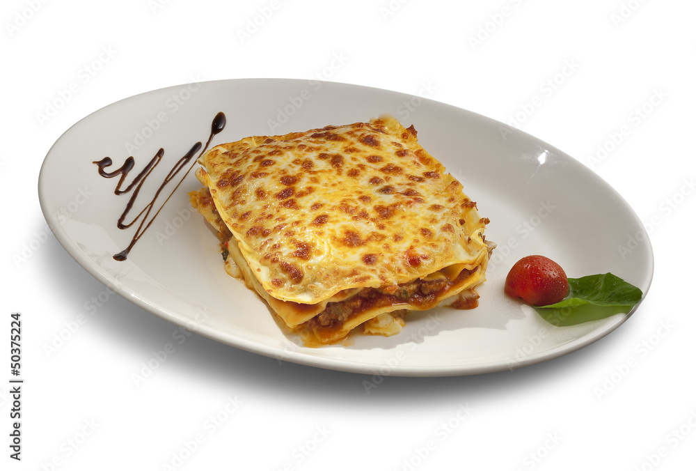 piece of lasagna with meat in a white plate and basil