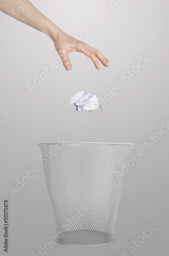 Hand throwing out paper
