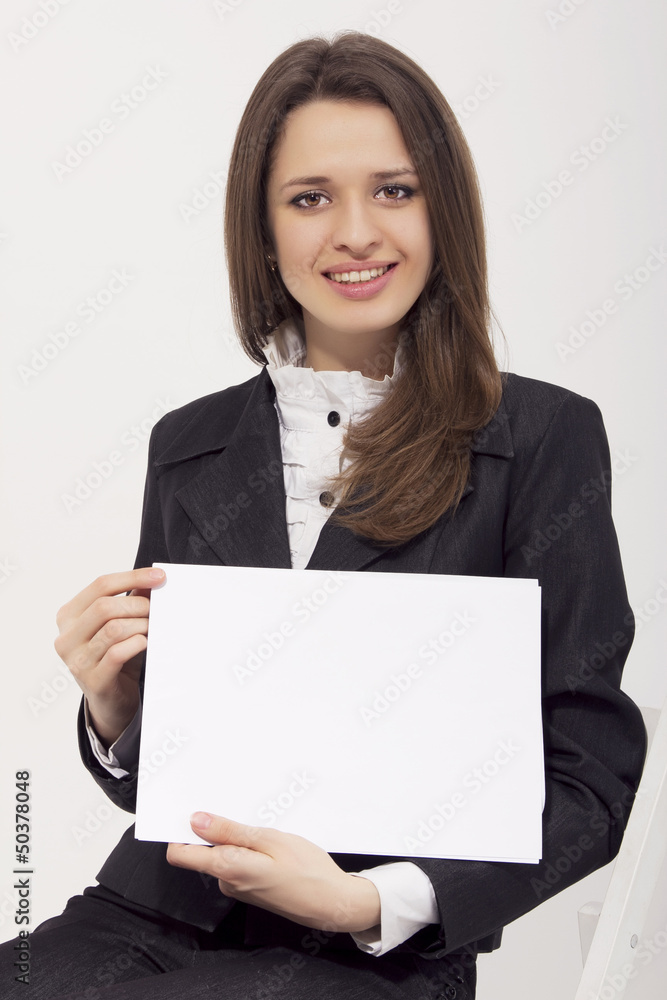 Attractive business woman holding blank paper isolated Attractive business woman holding blank paper isolated