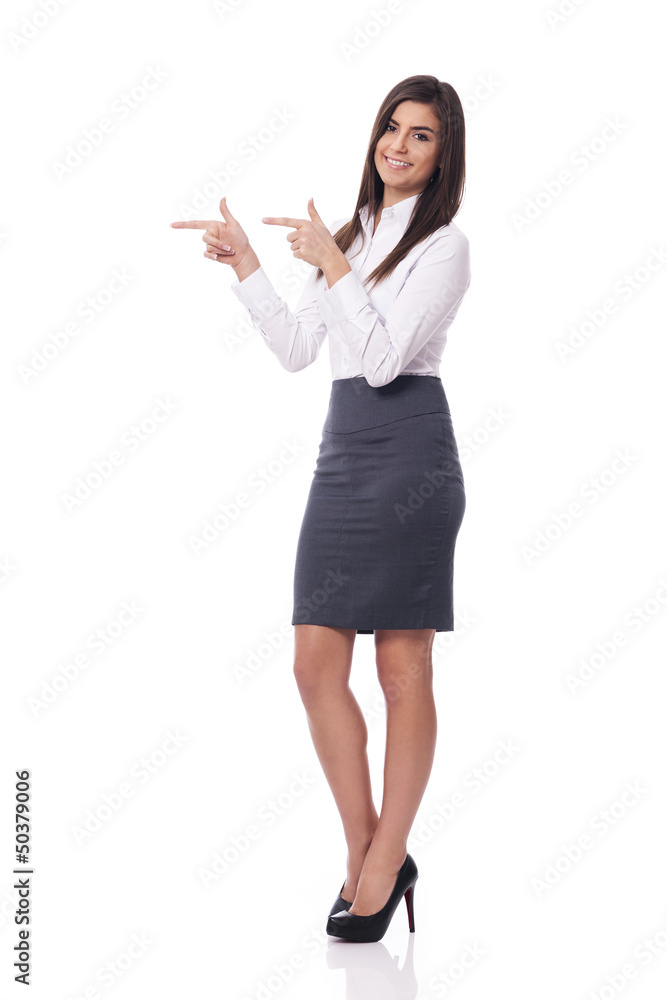 Smiling businesswoman pointing to copy space Smiling businesswoman pointing to copy space