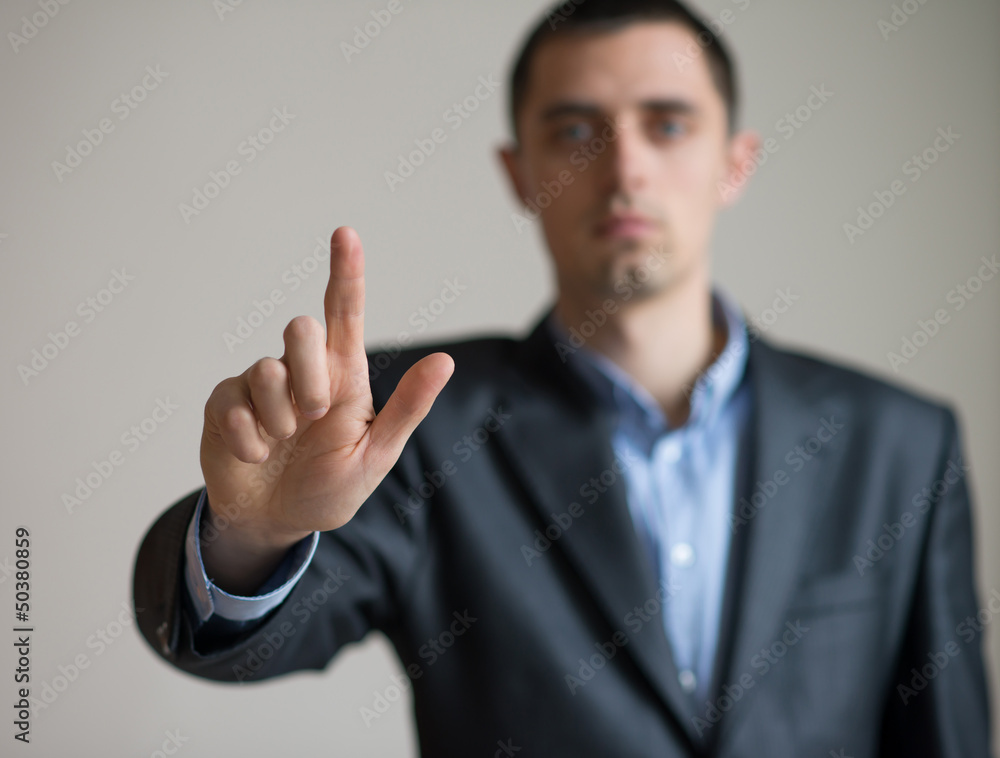 A man in a suit points finger A man in a suit points finger