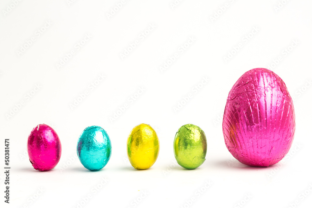 Fototapeta premium Four small easter eggs beside large one