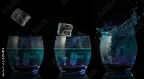 Serial arrangement of ice falling into glass of blue liquid