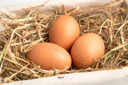 Three eggs in a white basket