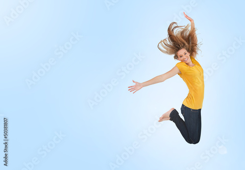 Canvastavla Pretty young woman jumping for joy