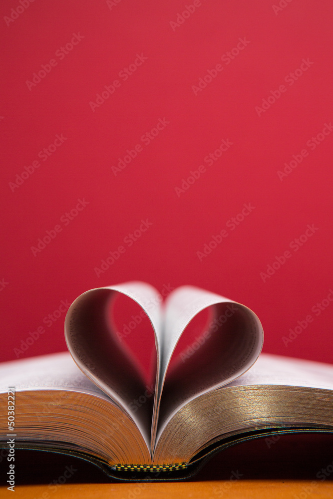 Embossed pages of book folded to make heart Embossed pages of book folded to make heart