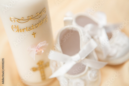 Fototapeta Baptism candle and baby booties