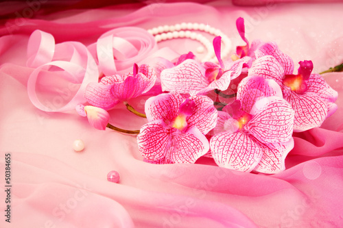 Fototapeta Naklejka Na Ścianę i Meble -  Cute pink orchids, necklace and beads