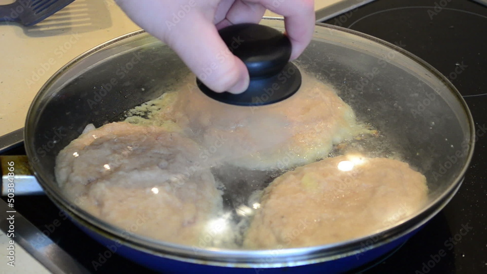 baking potatoes pancakes with meat. hand put lid on pan top baking potatoes pancakes with meat. hand put lid on pan top