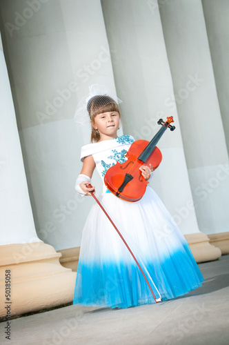 Violinist. Pretty girl in a smart dress with a violin