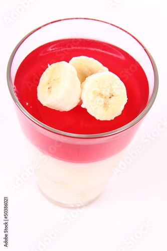 Pudding dessert with bananas and raspberry jelly