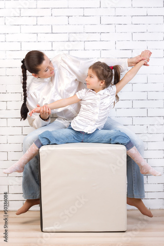 Mom and daughter in jeans, white shirts