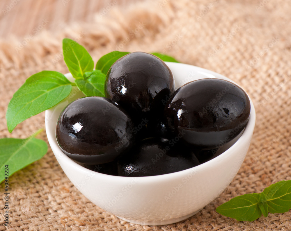 Black olives on a wooden table Black olives on a wooden table