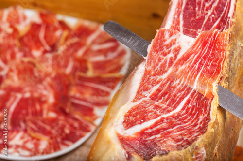 Slicing Spanish jamon iberico (ham) photo
