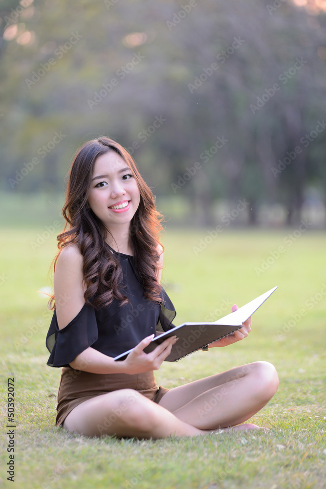 asia woman reading in the park