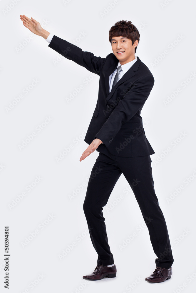 Young Asian business man showing something Young Asian business man showing something