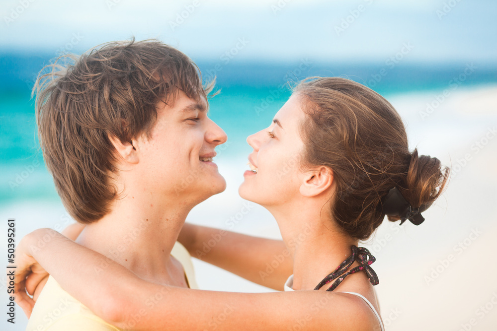 portrait of young happy couple having fun on tropical beach. portrait of young happy couple having fun on tropical beach.