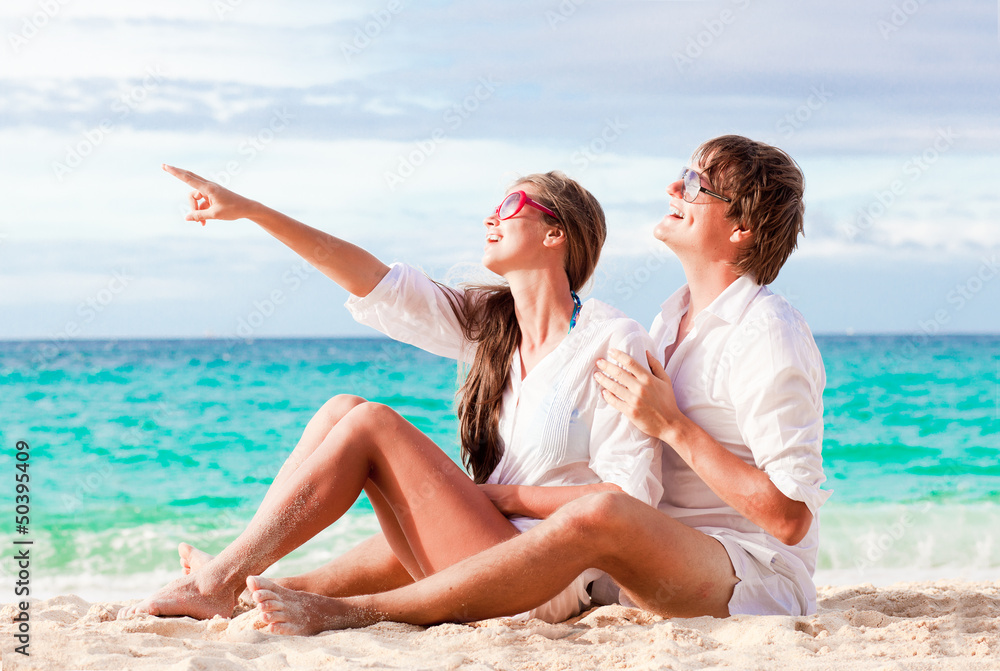 young happy couple having fun on tropical beach. honeymoon young happy couple having fun on tropical beach. honeymoon