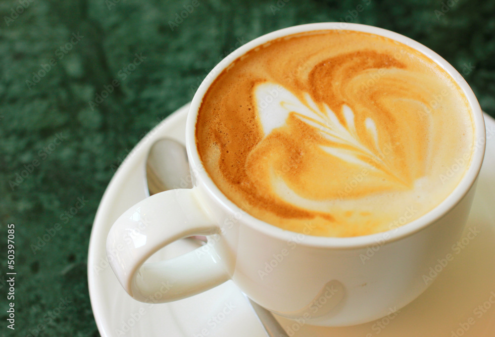 Cappuccino or latte coffee with spoon Cappuccino or latte coffee with spoon
