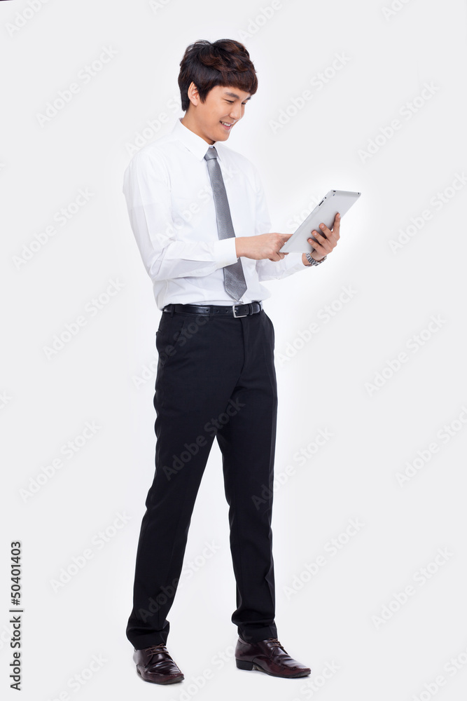 Young Asian business man using a pad PC Young Asian business man using a pad PC