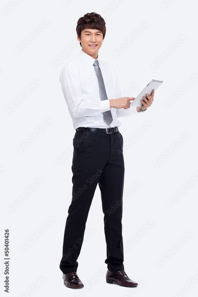 Young Asian business man using a pad PC Young Asian business man using a pad PC