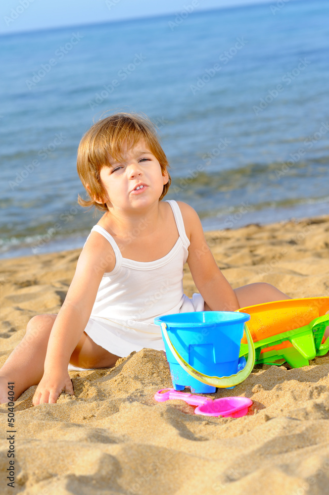 Happy toddler girl playing with her toys at beach Happy toddler girl playing with her toys at beach