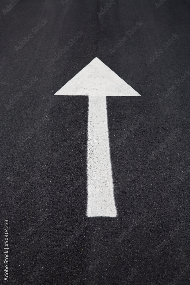 Arrow sign as road markings on a street Arrow sign as road markings on a street