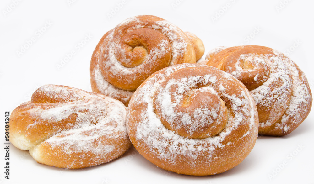 Group of delicious cinnamon rolls icing sugar isolated Group of delicious cinnamon rolls icing sugar isolated