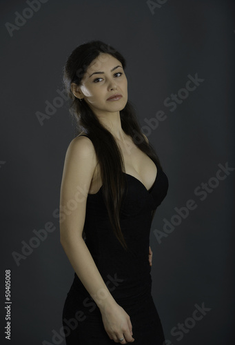 Portrait of beautiful brunette woman in black dress