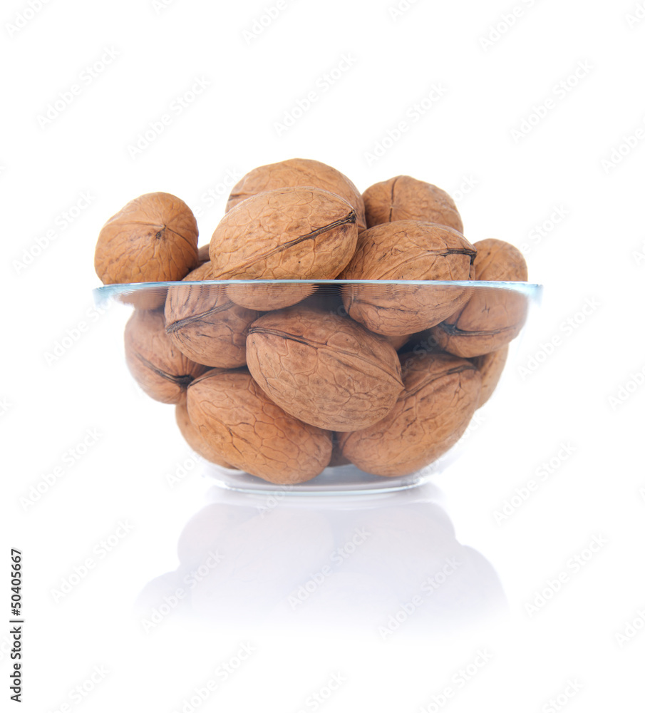 Walnuts in glass bowl isolated on white Walnuts in glass bowl isolated on white
