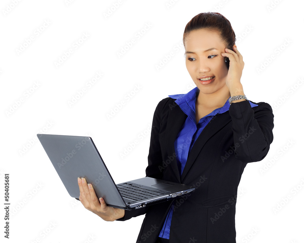 Isolated young business woman on a cell phne with laptop compute Isolated young business woman on a cell phne with laptop compute