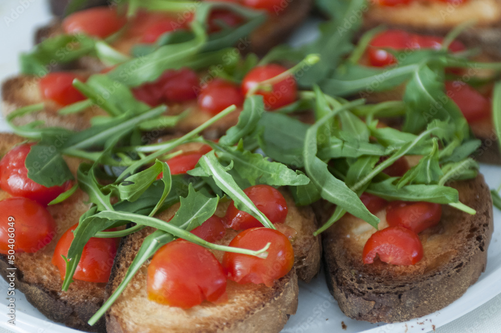 Toast with tomato and rocket salad