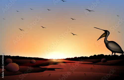 A sunset at the desert with a flock of birds