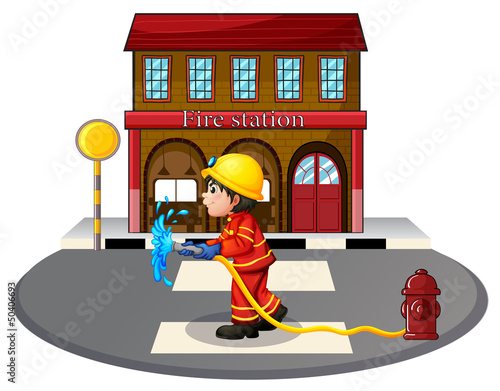 A fireman holding a fire hose near a hydrant