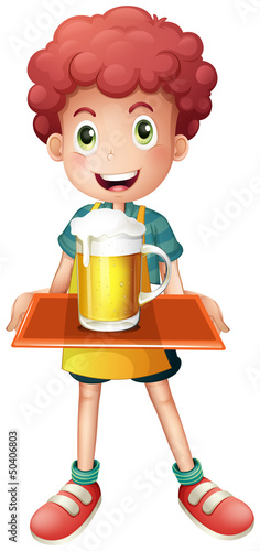 A young boy with a mug full of cold beer